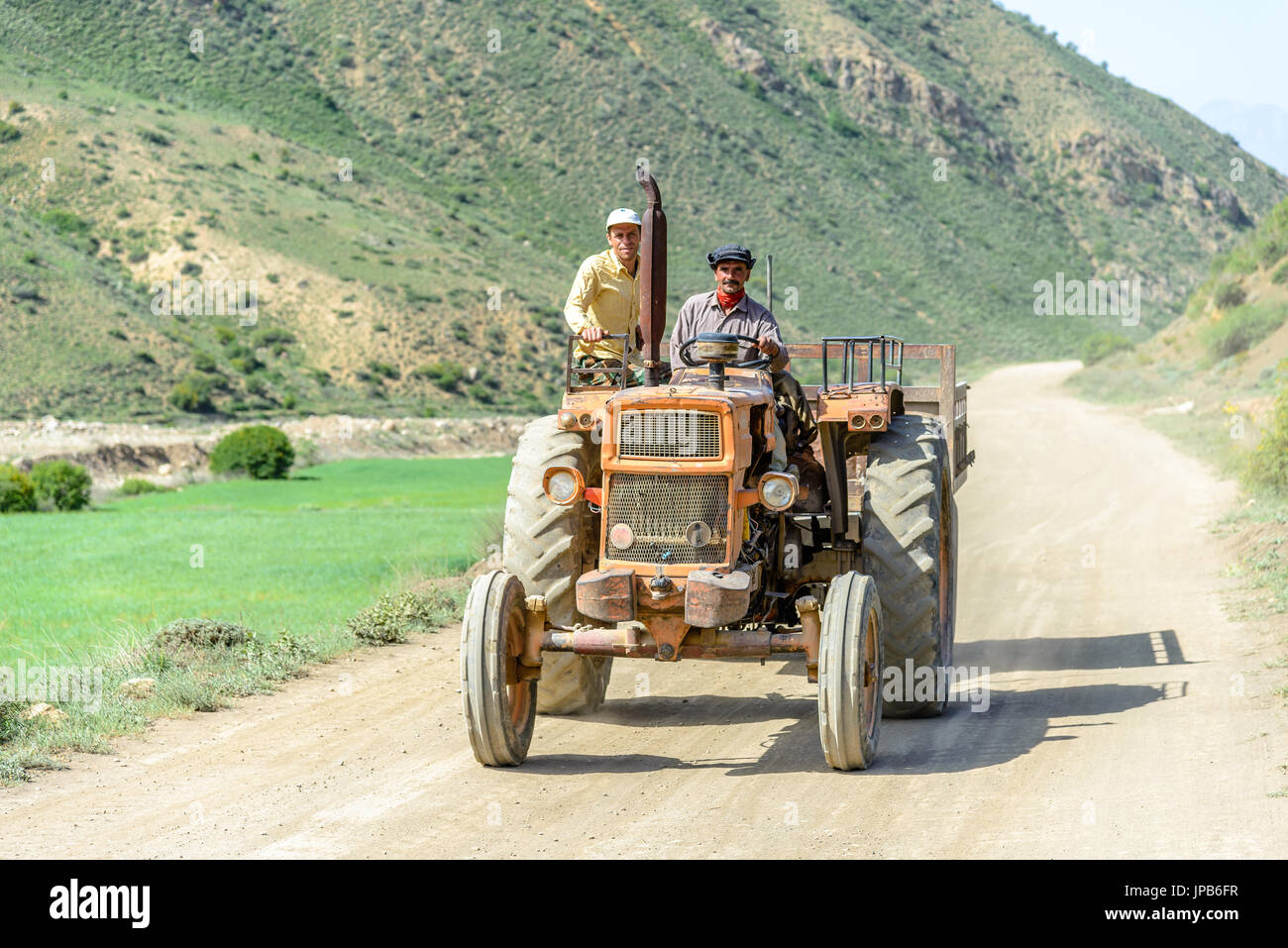 OROST, IRAN - MAY 03, 2015: traditional persian farmer on a tractor in the mountains of Iran Stock Photo