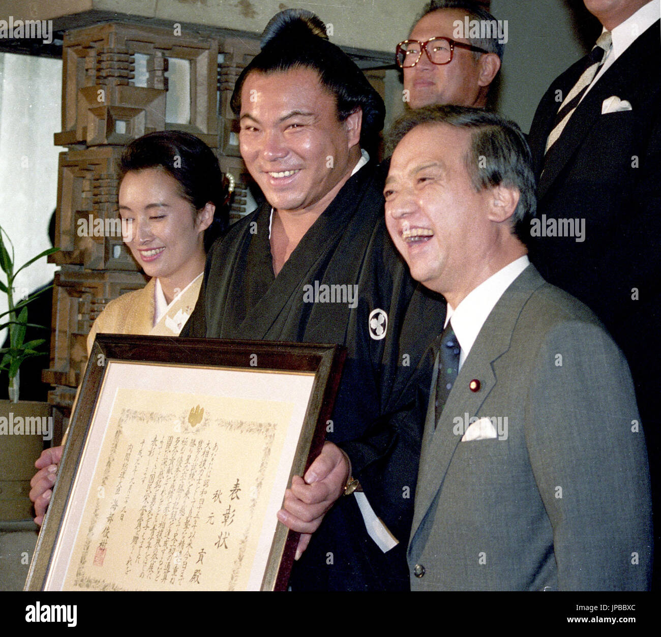 File photo shows sumo yokozuna (grand champion) Chiyonofuji (C) smiling 