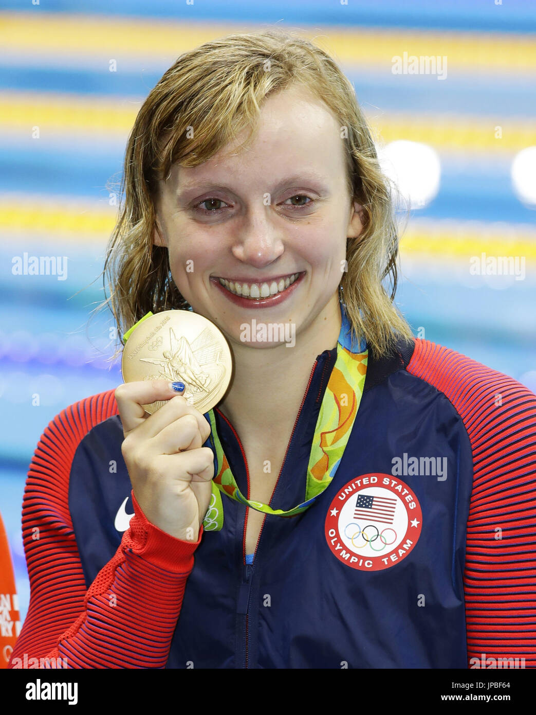 Katie Ledecky of the United States shows the gold medal she won in the