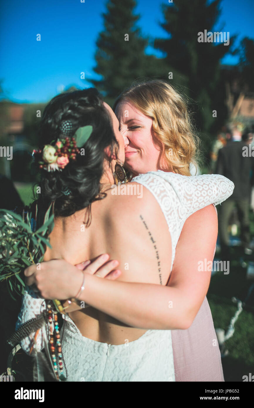 Bride and witness at alternative wedding outside, happiness, embrace, half portrait Stock Photo