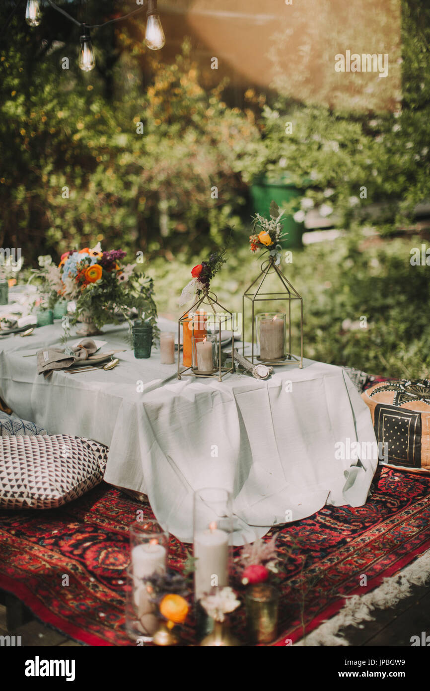 Festive laid table at alternative wedding celebration outside Stock