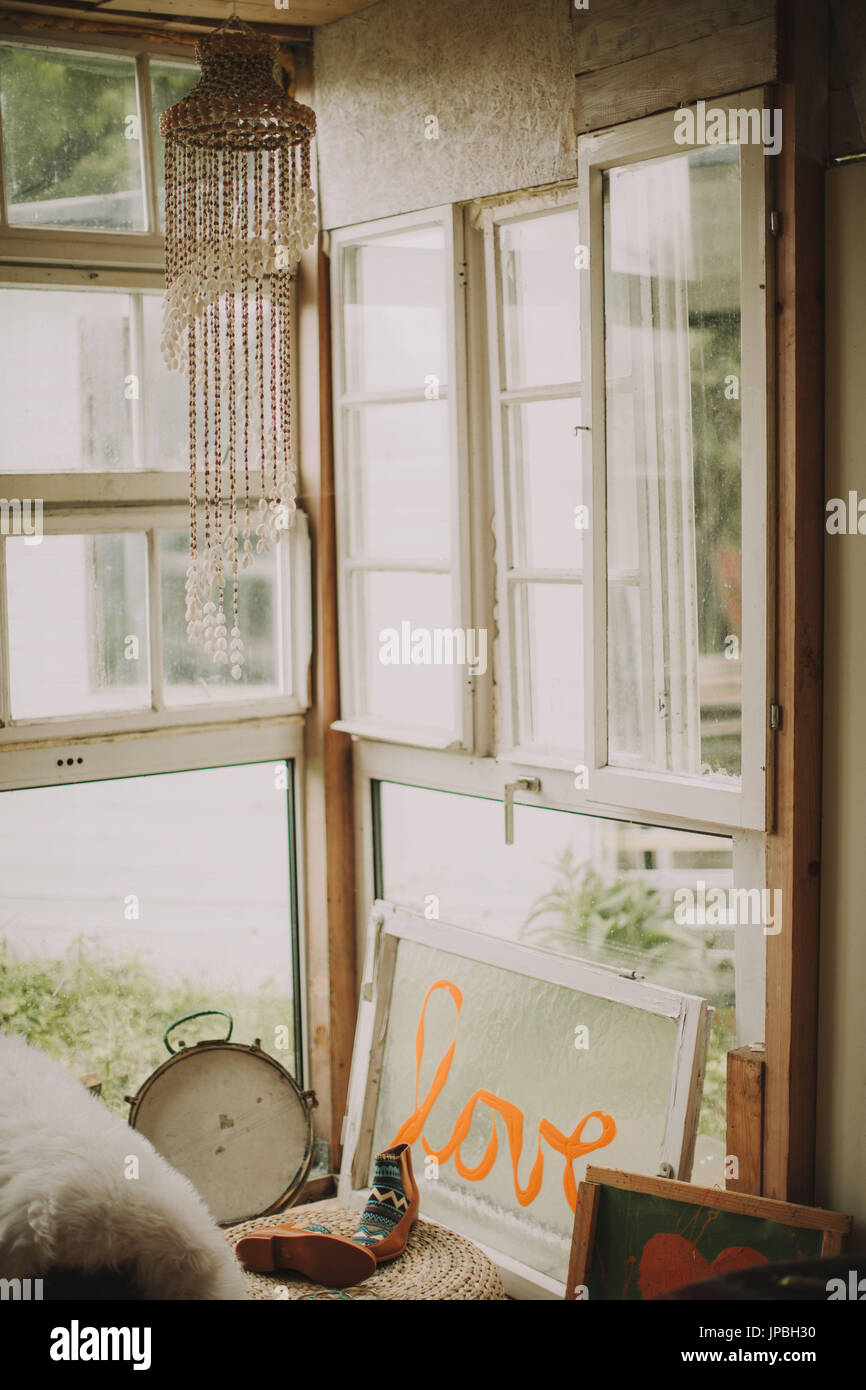 Alternative interior furnishing in a garden shed, window with the inscription 'Love' Stock Photo