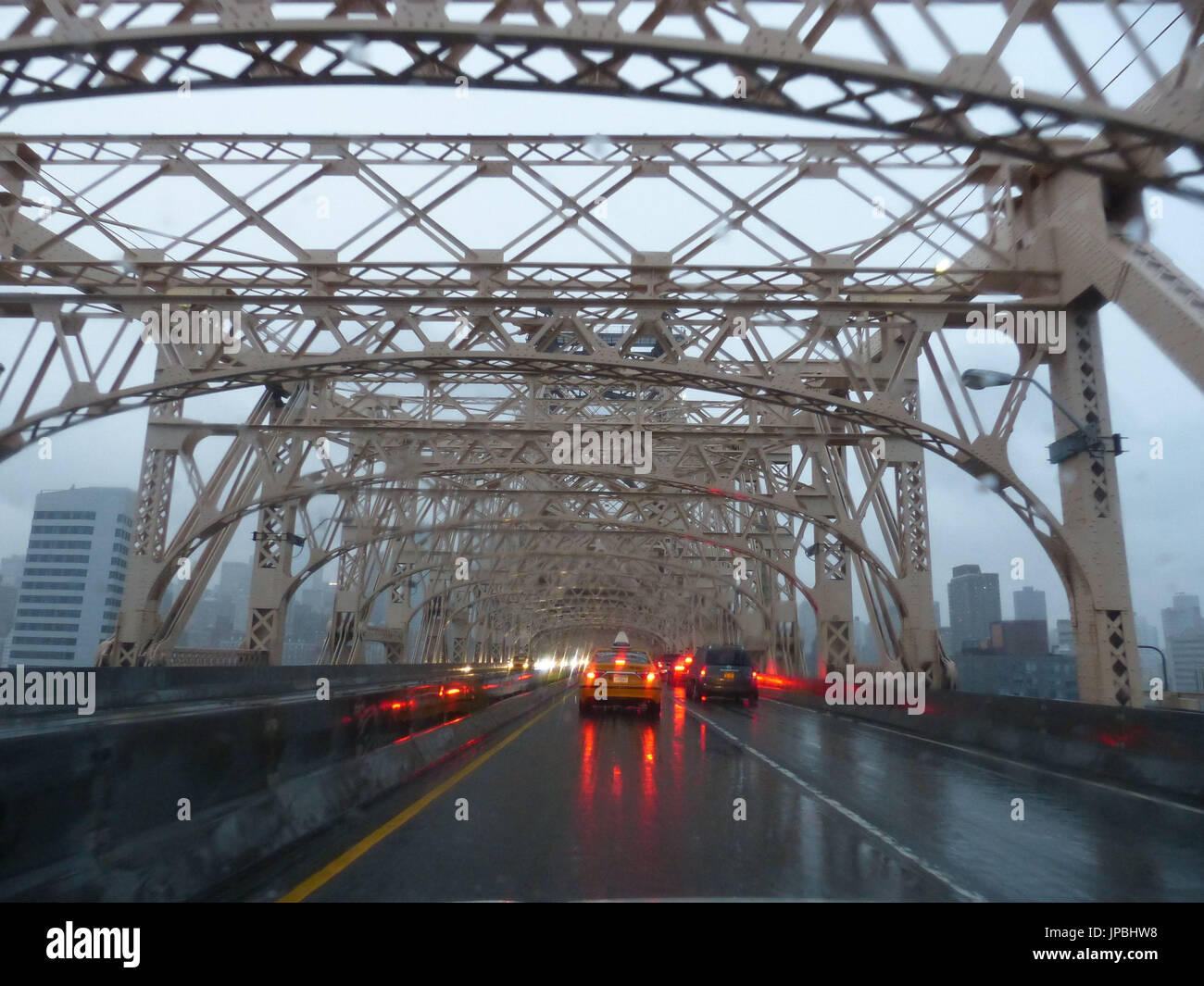 Vehicles with brake lights during rain crossing Queensborough Bridge, aka 59th Street Bridge, aka Ed Koch 59th Street Bridge or Ed Koch Queensborough Bridge Stock Photo