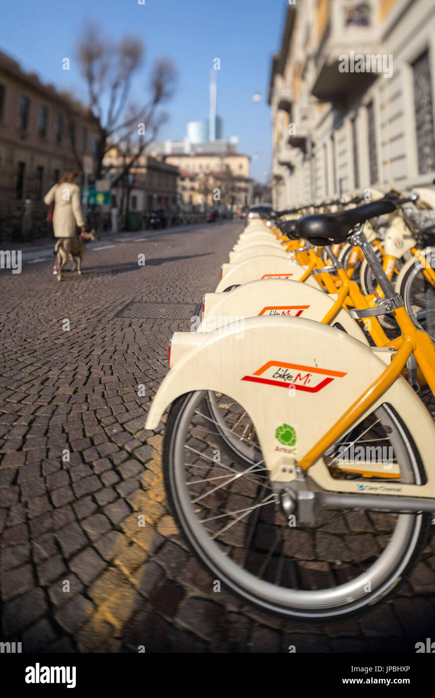 Yellow city bikes sharing and in the old town center of Milan Lombardy Italy Europe Stock Photo