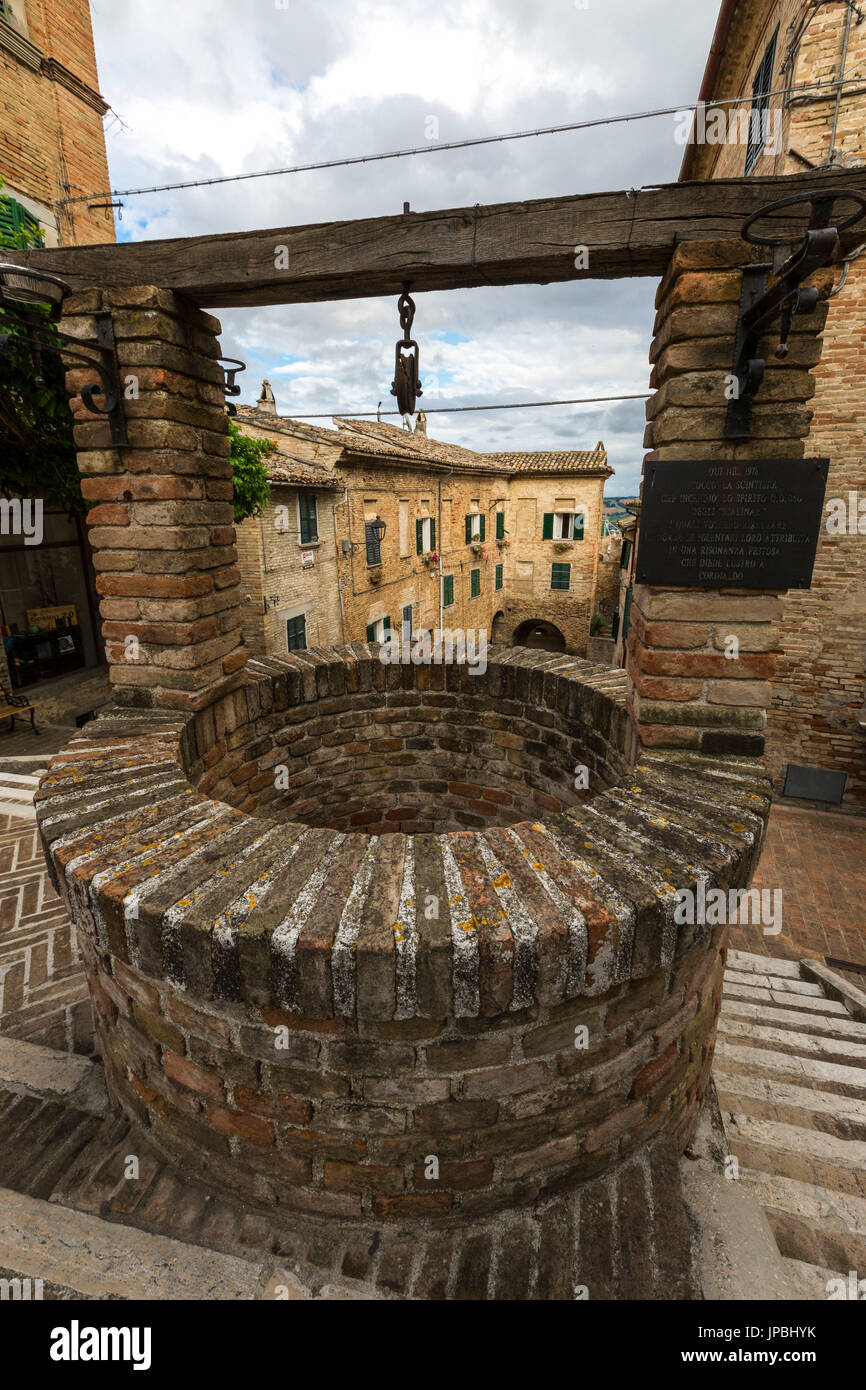 The ancient stone well among the houses of the old town of Corinaldo Province of Ancona Marche Italy Europe Stock Photo