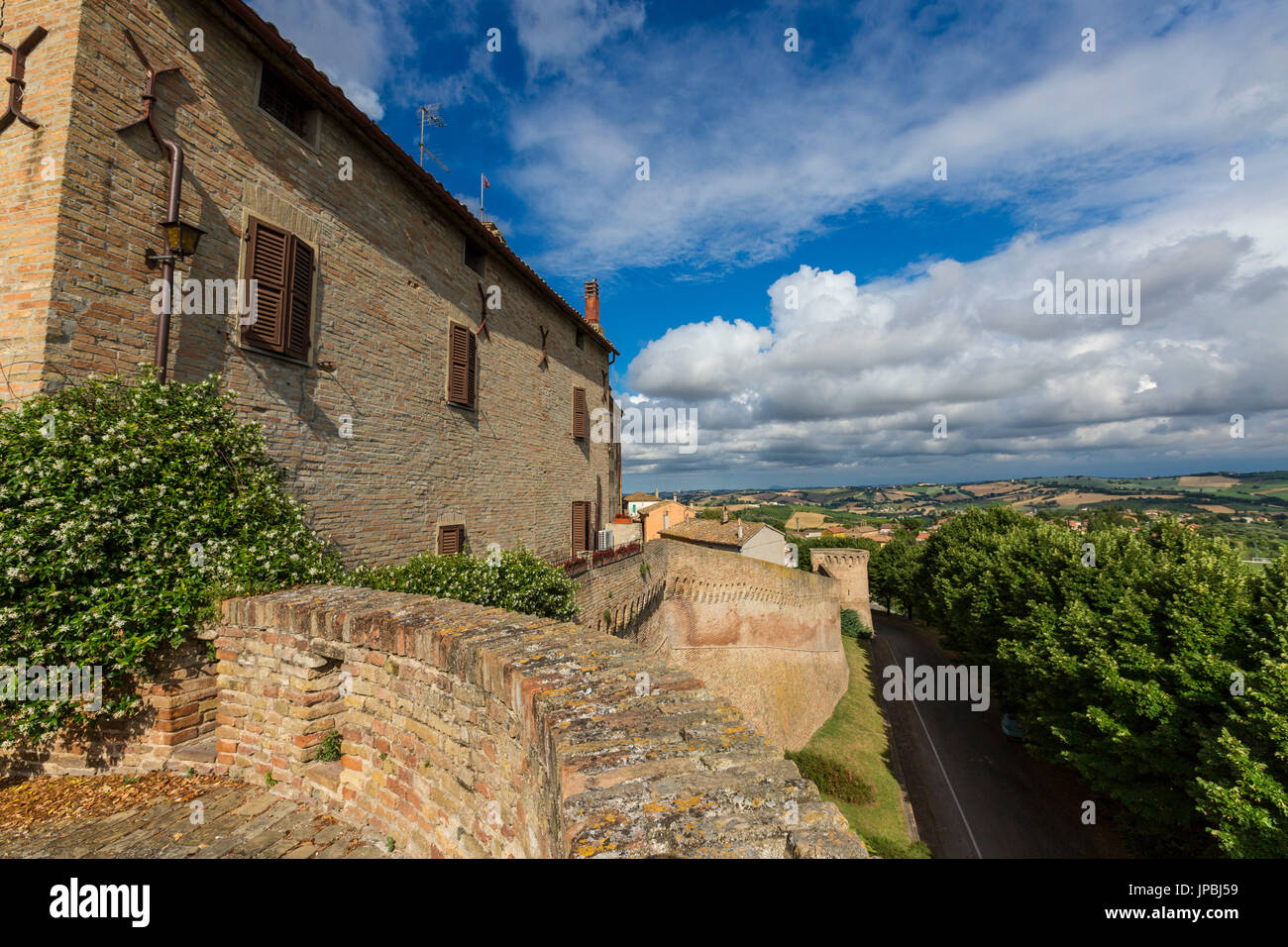 Blue sky frames the typical buildings of the old town surrounded by fields Corinaldo Province of Ancona Marche Italy Europe Stock Photo