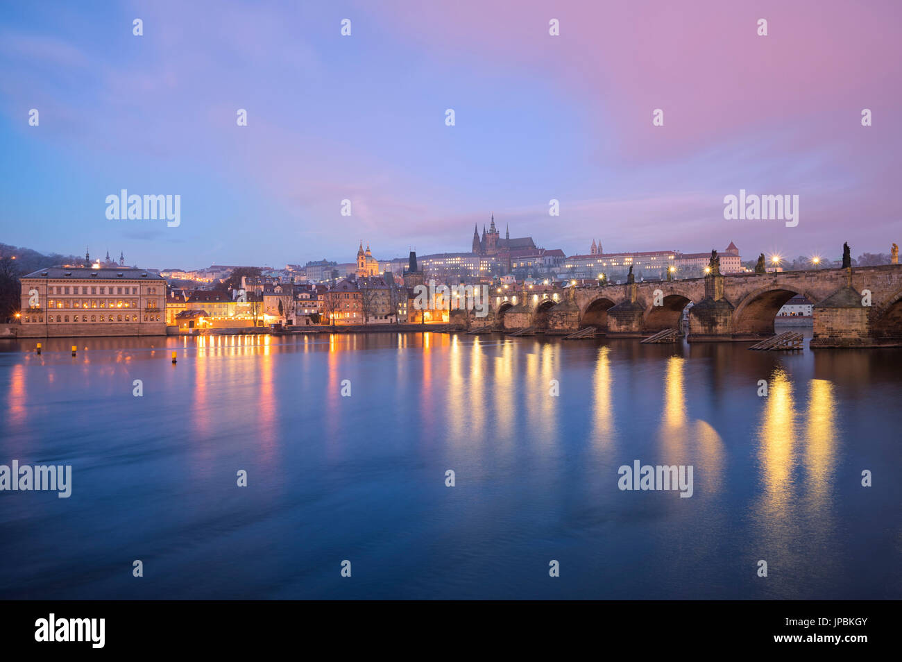 Prague, Czech Republic Charles Bridge, the castle and a glimpse of the city photographed at dawn Stock Photo