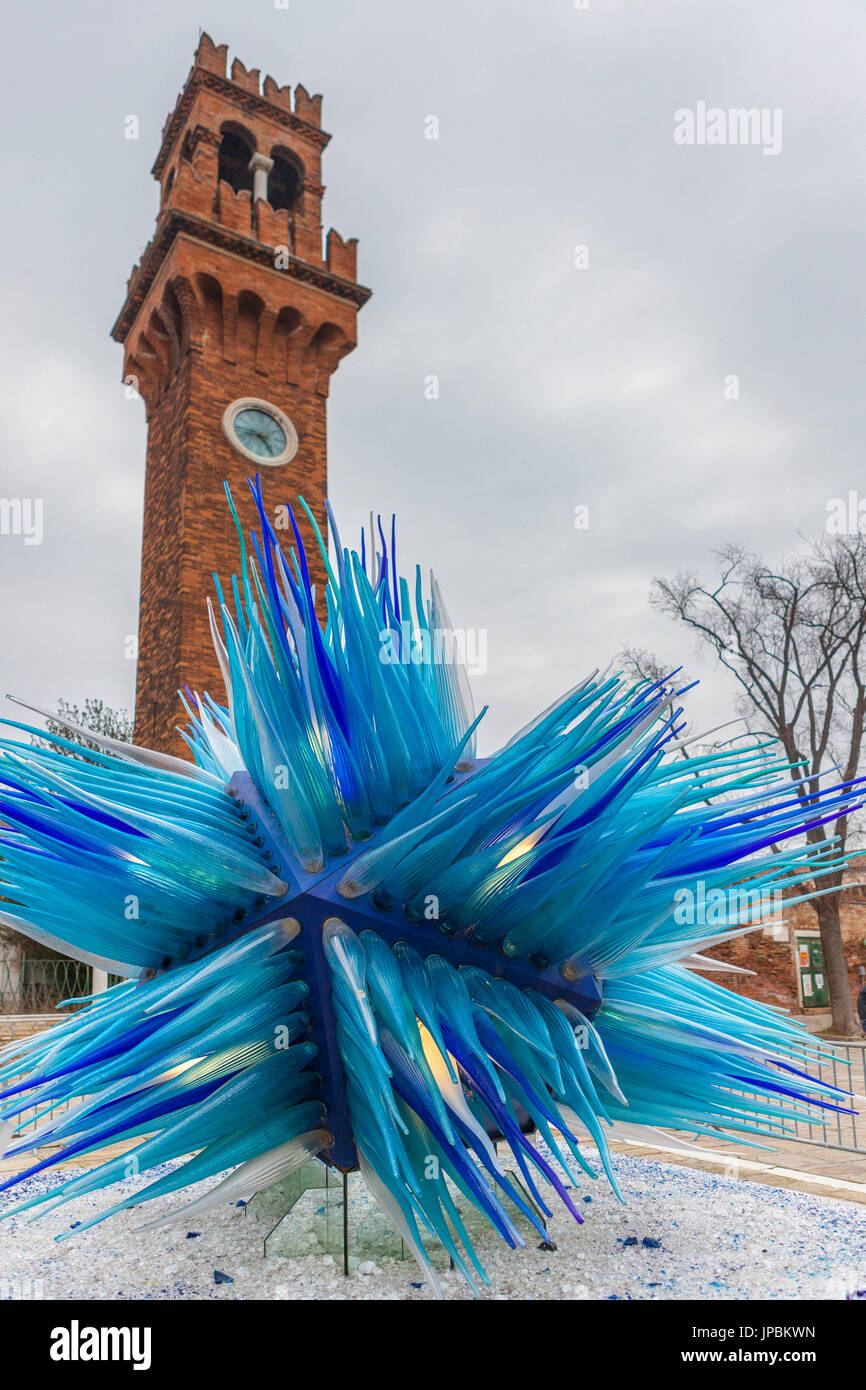 The blue glass sculpture frames the bell tower at Campo Santo Stefano Island of Murano Veneto Italy Europe Stock Photo