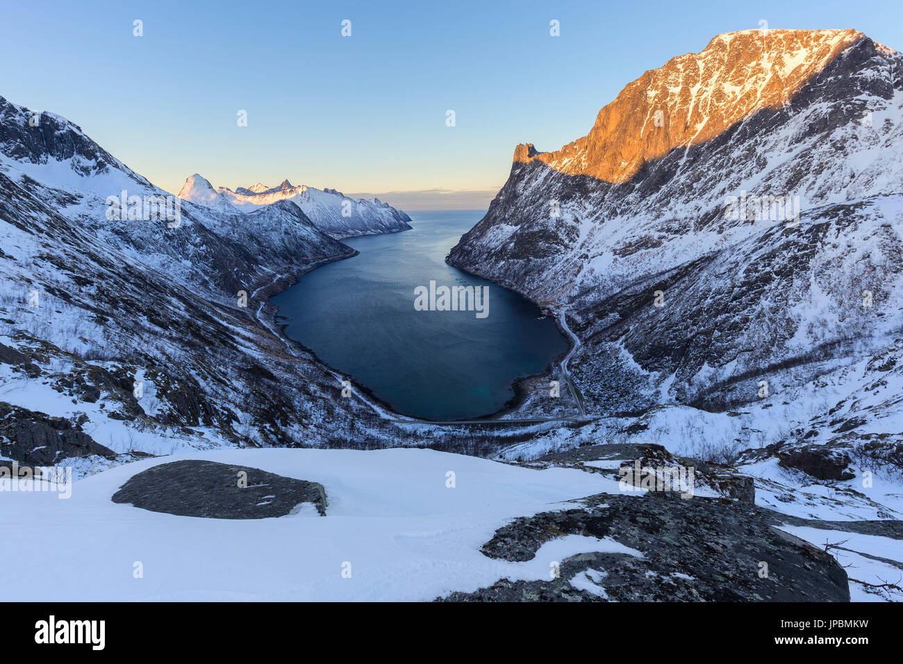 View of Oyfjorden during the last sun illuminating the peaks. Barden, Mefjordbotn, Mefjorden, Senja, Norway, Europe. Stock Photo