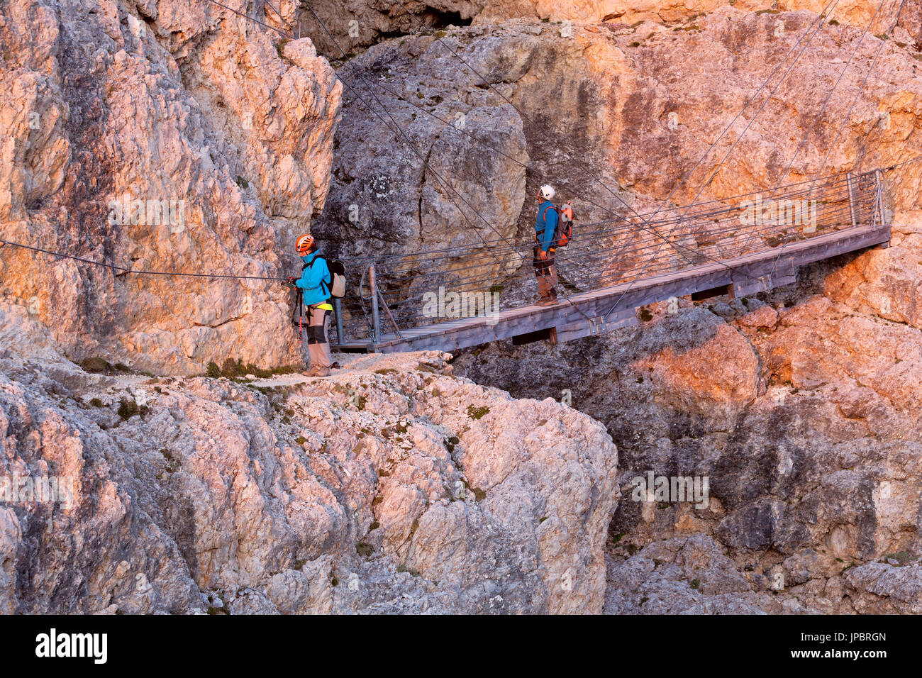 Walking the path of Kaiserjaeger you reach a secured walking section and a suspension bridge with steel cables 15 meters long (rebuilt in the same place as the original Austrian anchors which are still visible, the teeth and the supporting portions of the ropes originals). Dolomites, Lagazuoi, Italy Stock Photo