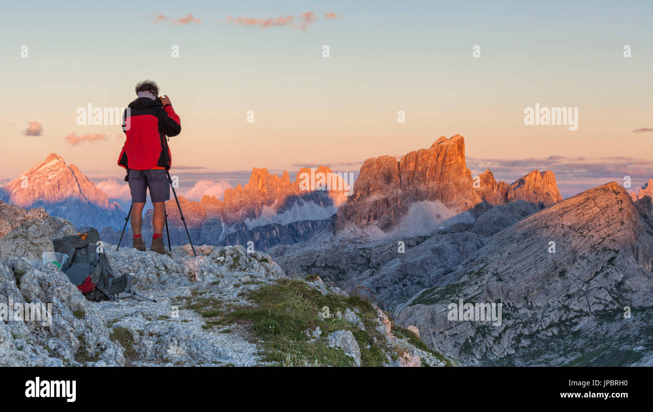 Europe, Italy, Veneto, Belluno, Cortina d Ampezzo. Landscape photographer at sunset on the top of Sass de Stria, Dolomites Stock Photo