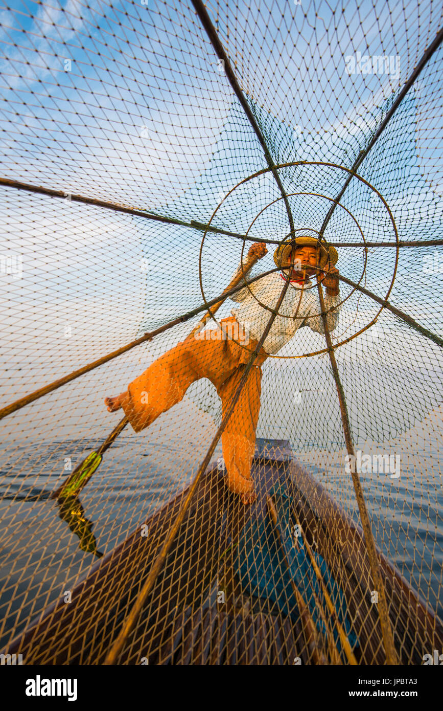 Inle lake, Nyaungshwe, Shan state, Myanmar. Fisherman looking through the fishing net. Stock Photo