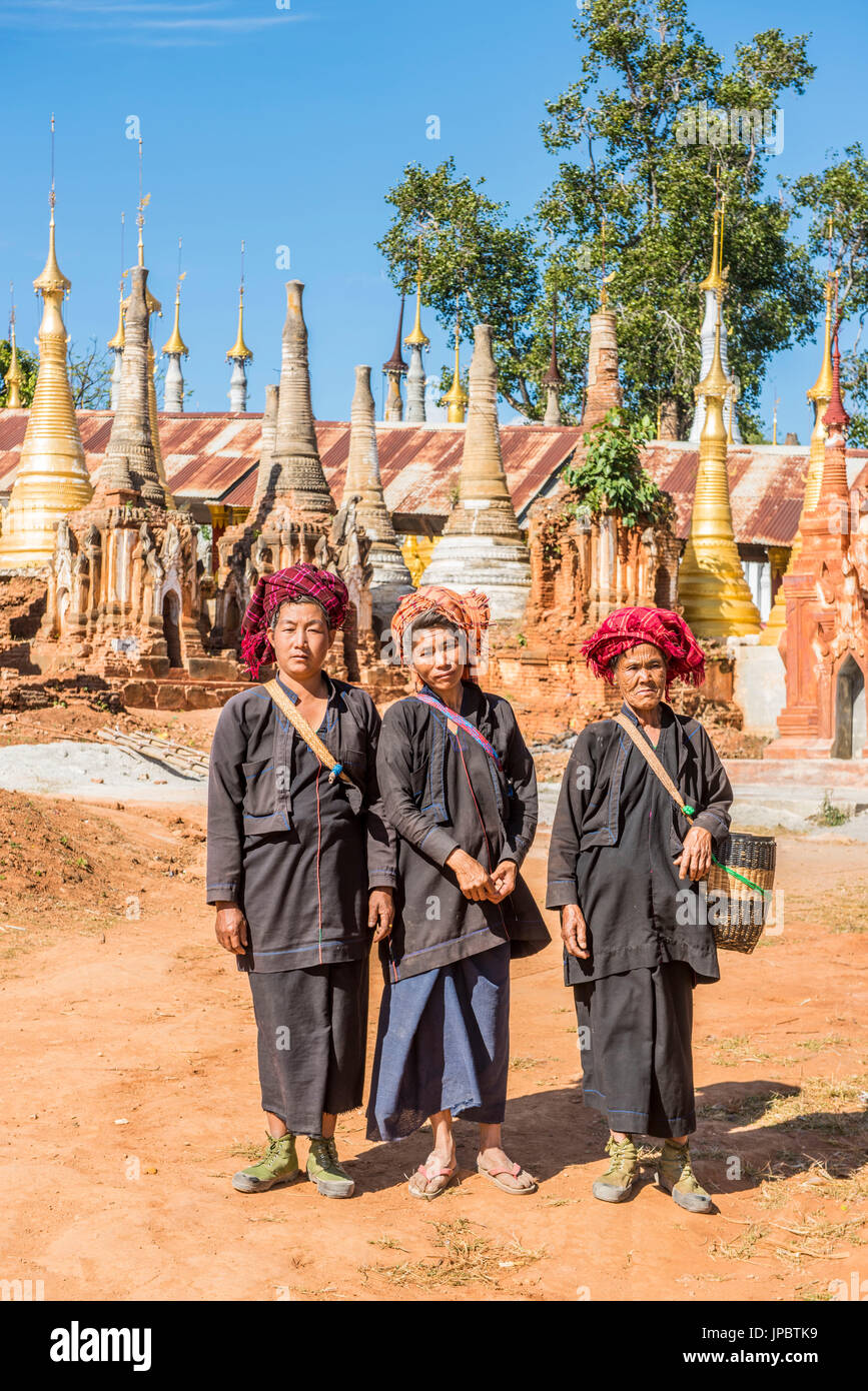 Indein, Inlay Lake, Shan State, Myanmar. Women posing among the stupas of the Shwe Indein Pagodas. Stock Photo