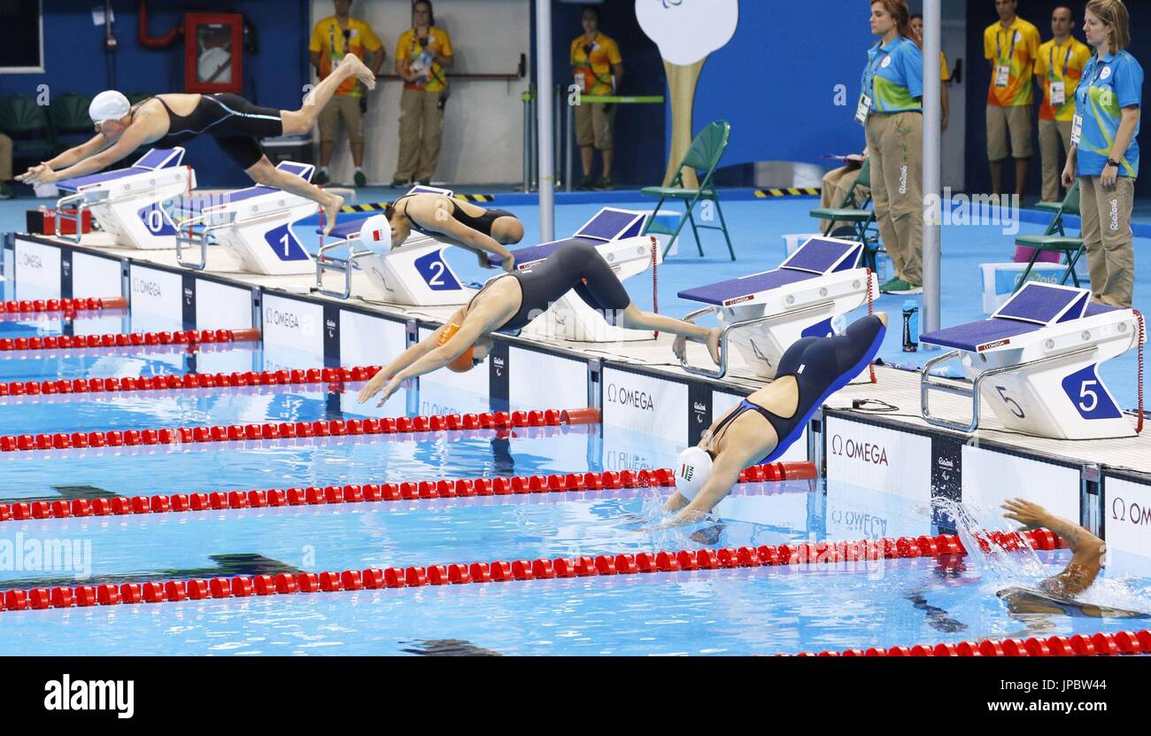 Swimmers dive into the pool in a variety of styles in the women