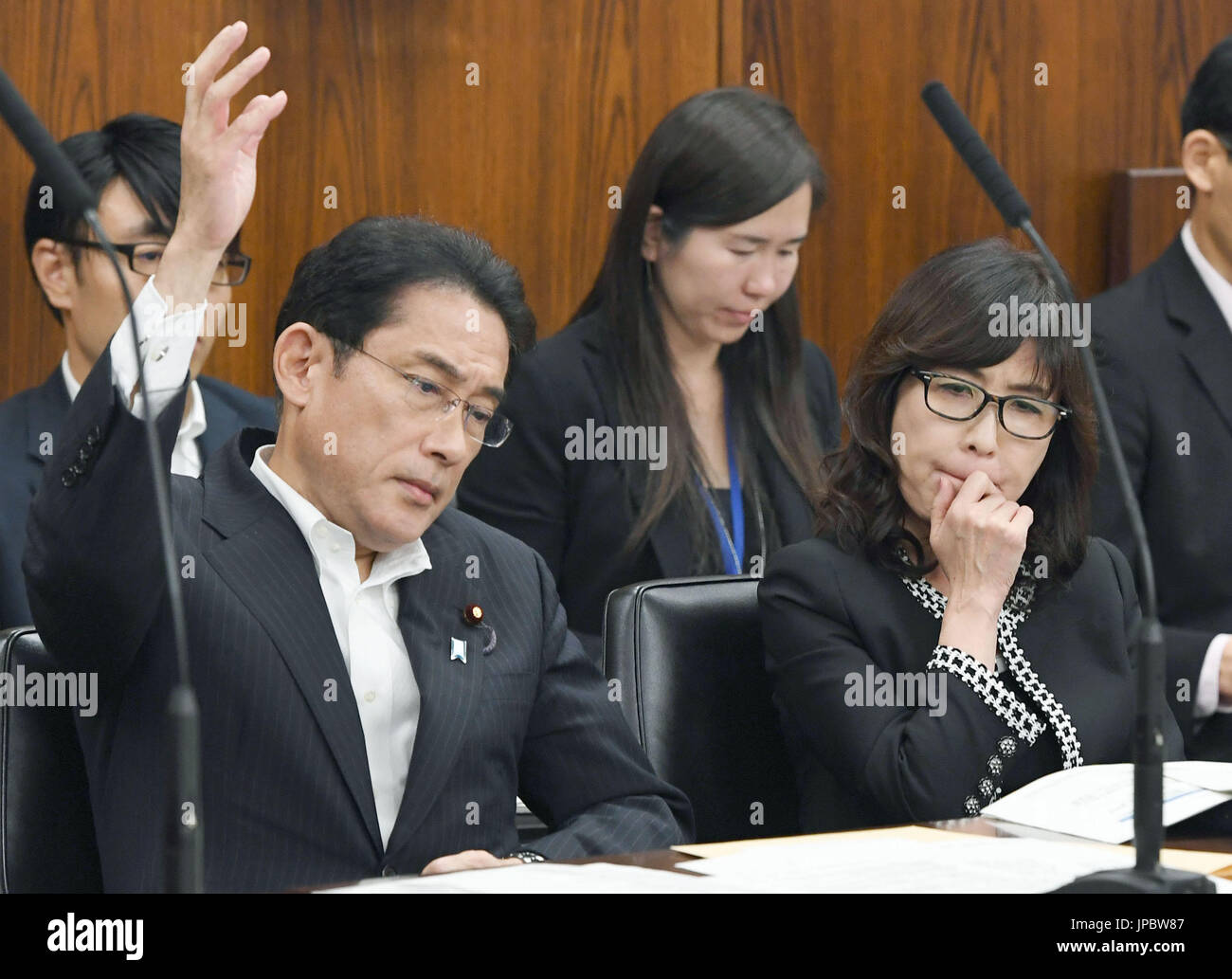 Japanese Foreign Minister Fumio Kishida (L in front row) raises his ...