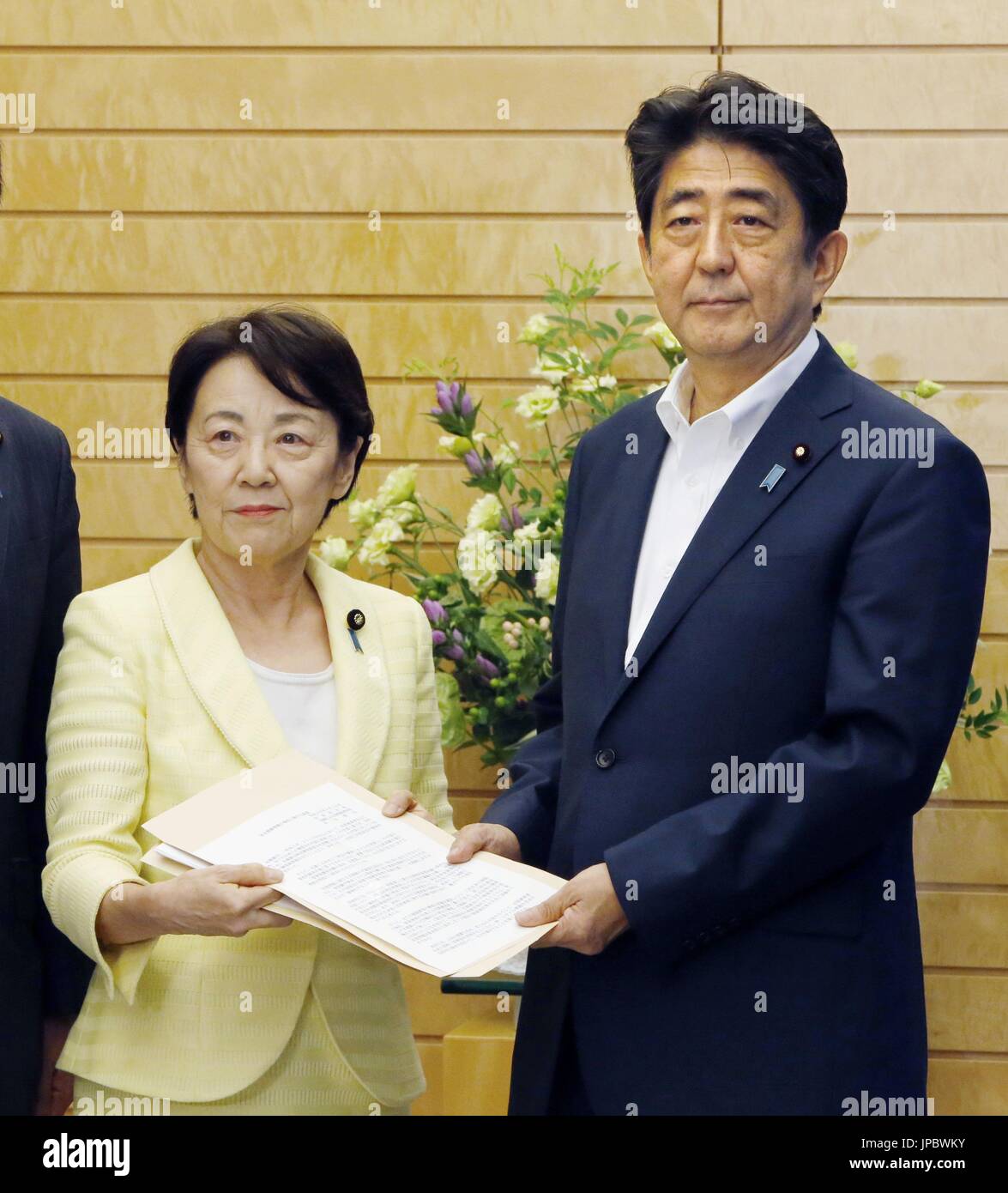 Eriko Yamatani of the Liberal Democratic Party hands a written proposal