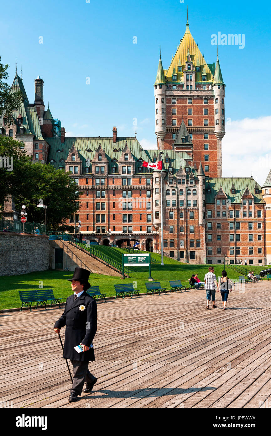 Quebec City, Canada, North America. Le Chateau Frontenac castle with people walking along Dufferin Terrace boardwalk. Stock Photo