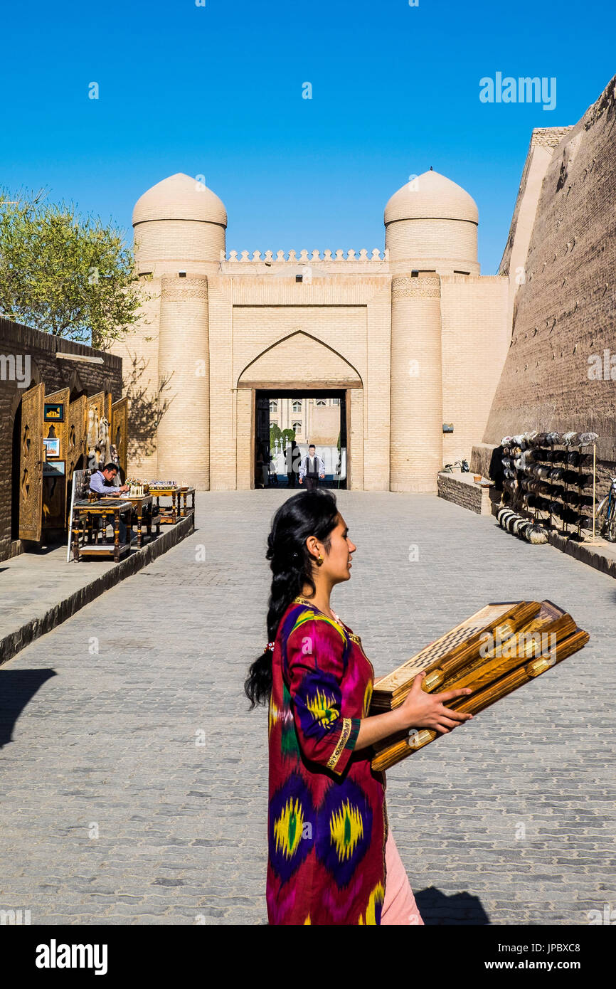 Khiva. Uzbekistan, Central Asia. Woman walking in the street. Stock Photo