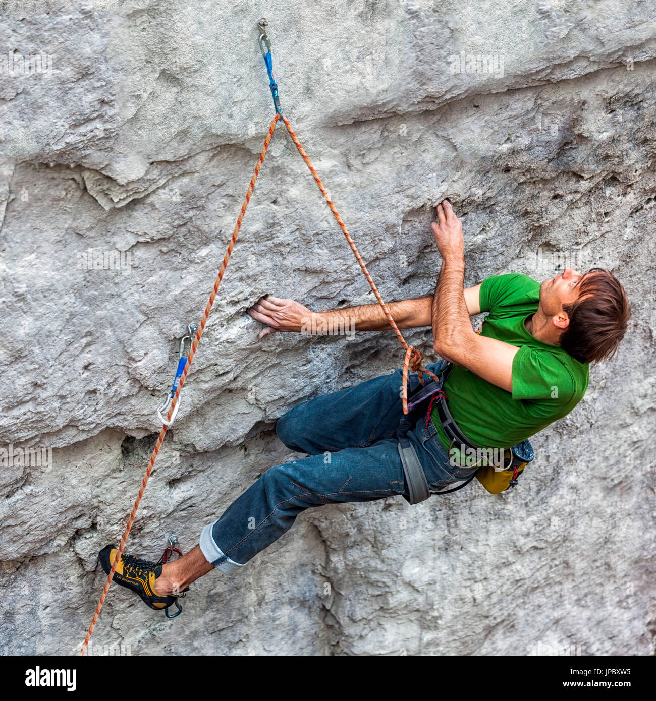 Free climbing, rock climbing in natural cliff. Climber in action on a