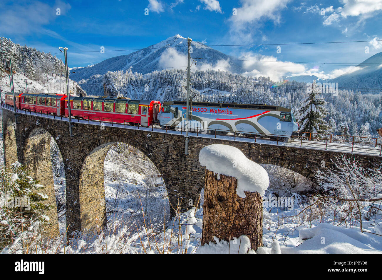 Filisur Pass Bernina Express passes through the snowy woods Filisur Canton of ...