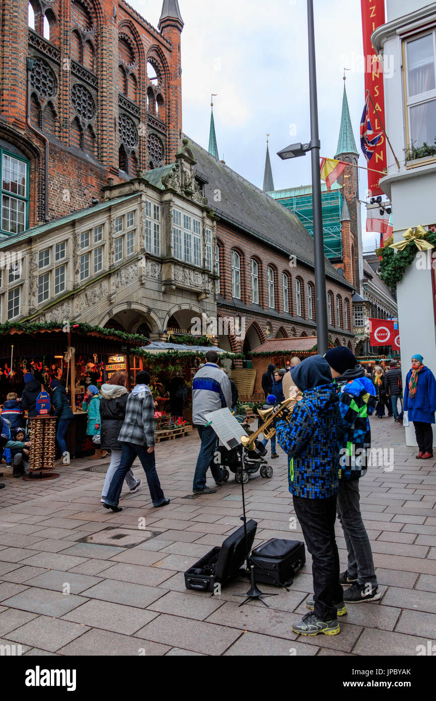 Street musicians and tourists in the old gothic style city center of Lübeck Schleswig Holstein Germany Europe Stock Photo