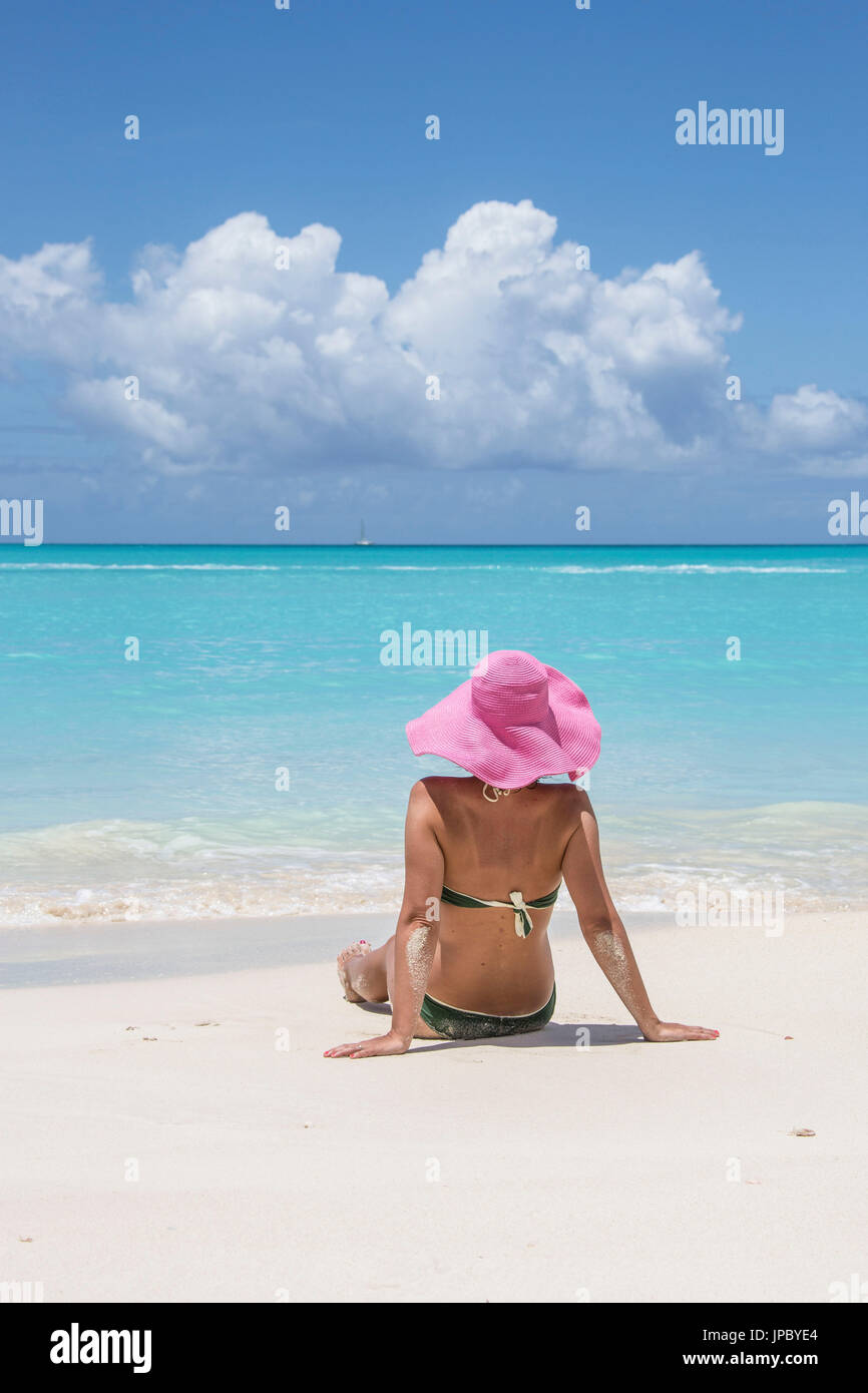 Tourist admires the turquoise Caribbean Sea Jolly Beach Antigua and Barbuda Leeward Island West Indies Stock Photo