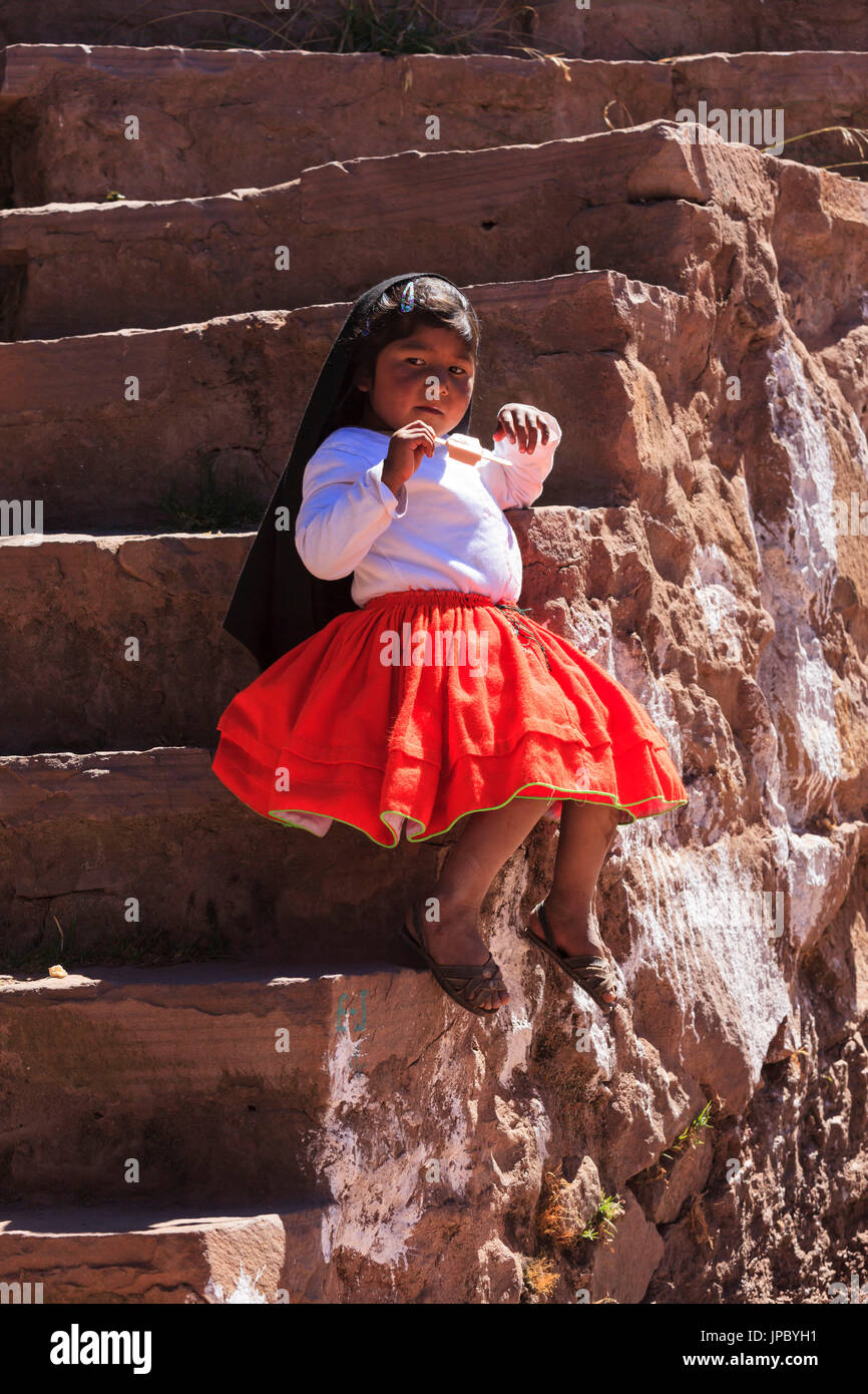 Child dressed for a ceremony on Isla Taquile on the Peruvian side of Lake Titicaca, Puno province, Peru Stock Photo