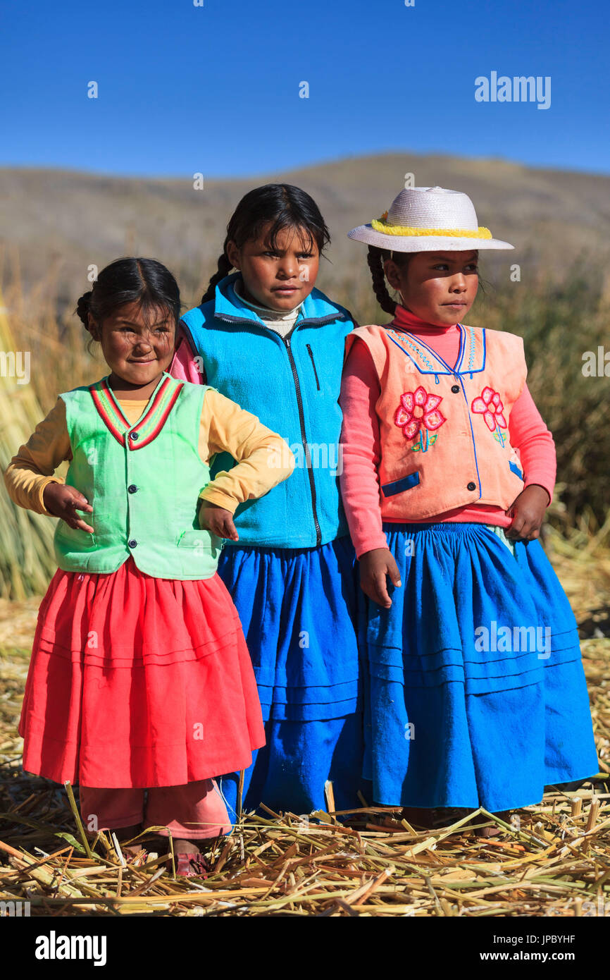 Children leaving on the Uros floating islands on Lake Titicaca, Puno, Peru Stock Photo