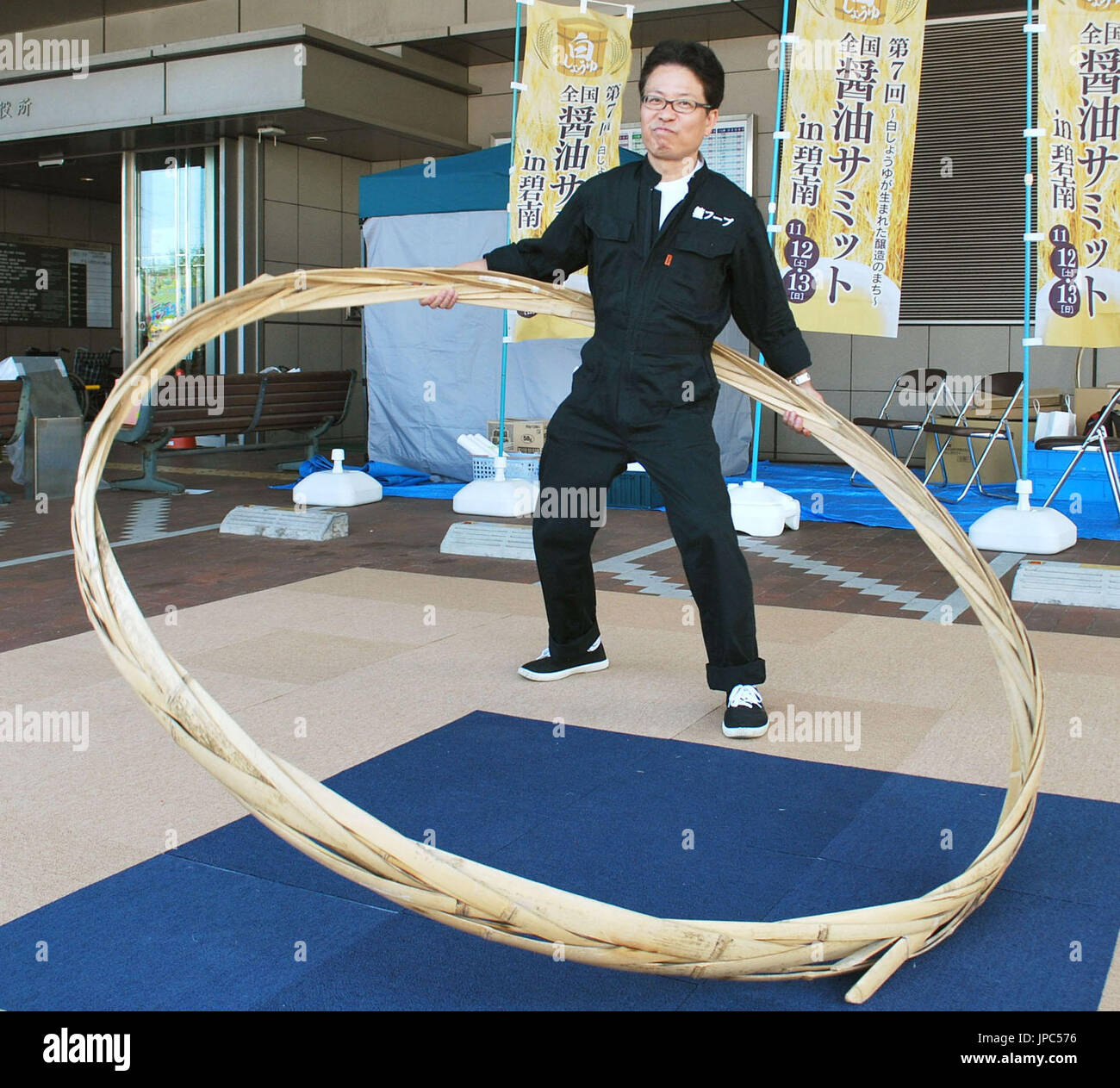 Yoichi Ninagawa, president of Nitto Jozo Inc., a white soy sauce maker, stands with a Taga Hoop in Hekinan, Aichi Prefecture in July 2016. Japanese soy sauce and miso fermented soybean paste makers have been holding competitions to hula "taga," or the bamboo hoop used to fasten the wooden barrel that holds the fermented products, in a bid to maintain the condiments' traditional production method. (Kyodo) ==Kyodo Stock Photo