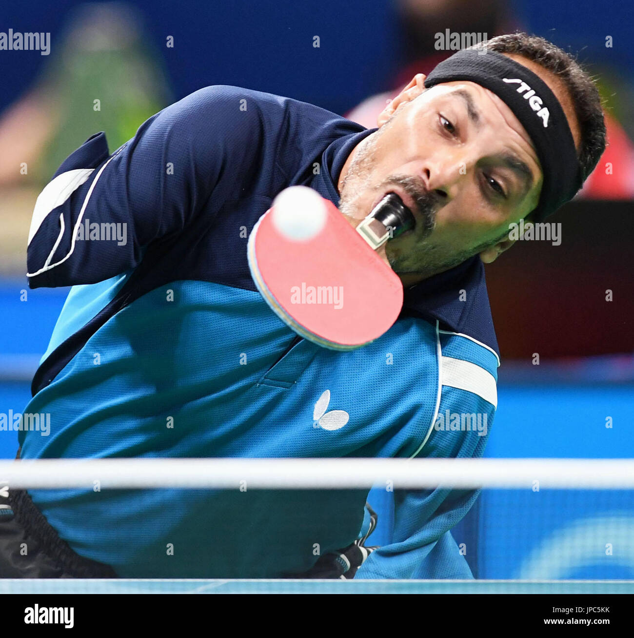 Ibrahim Hamadtou, an Egyptian armless table tennis player, holds the