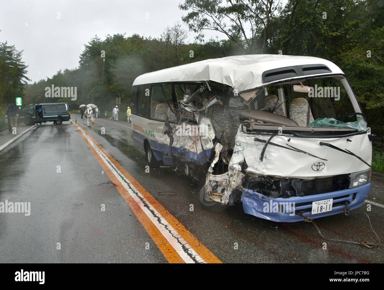 A bus (front) and a passenger car collide in the central Japan city of ...