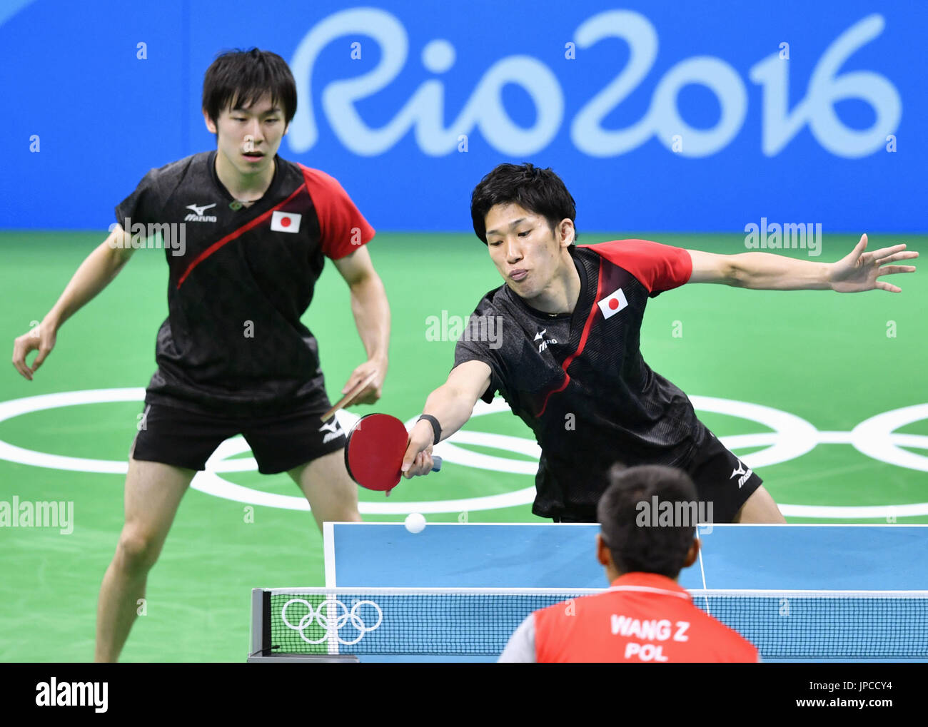 Japan's Koki Niwa (L) and Maharu Yoshimura compete against Wang Zengyi