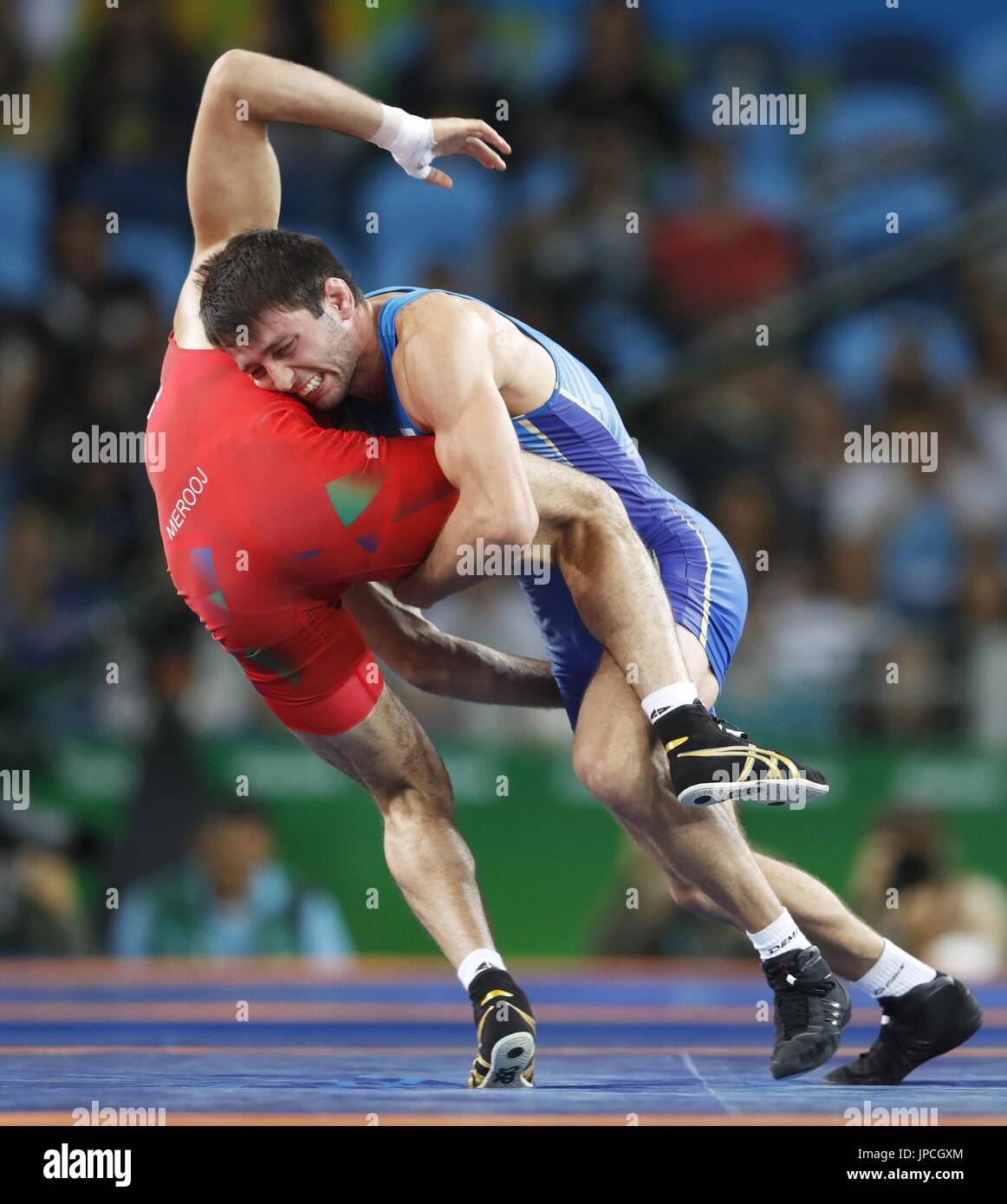 Russian freestyle wrestler Soslan Ramonov (R) competes against Toghrul
