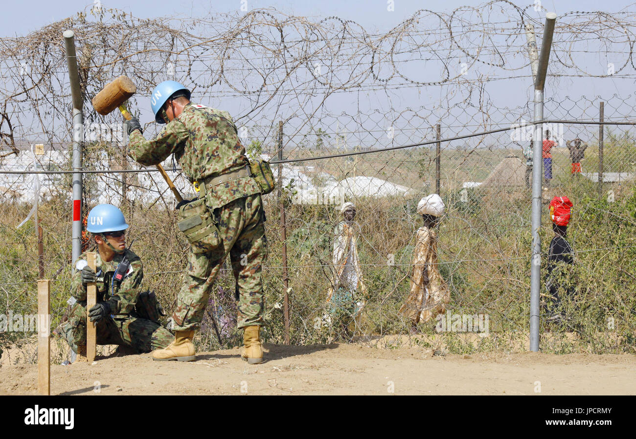 Japanese Ground Self-Defense Force personnel work to set up safety ...