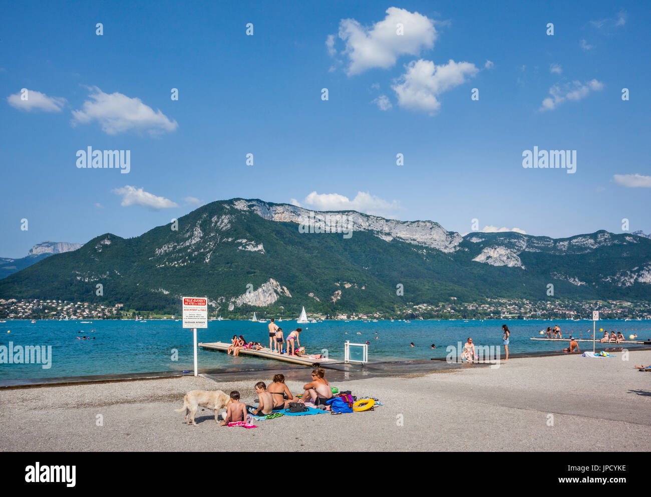 France, Annecy, sunseekers on the shores of Lake Annecy at Marquisats Nautical Base enjoy a sunny summer day Stock Photo