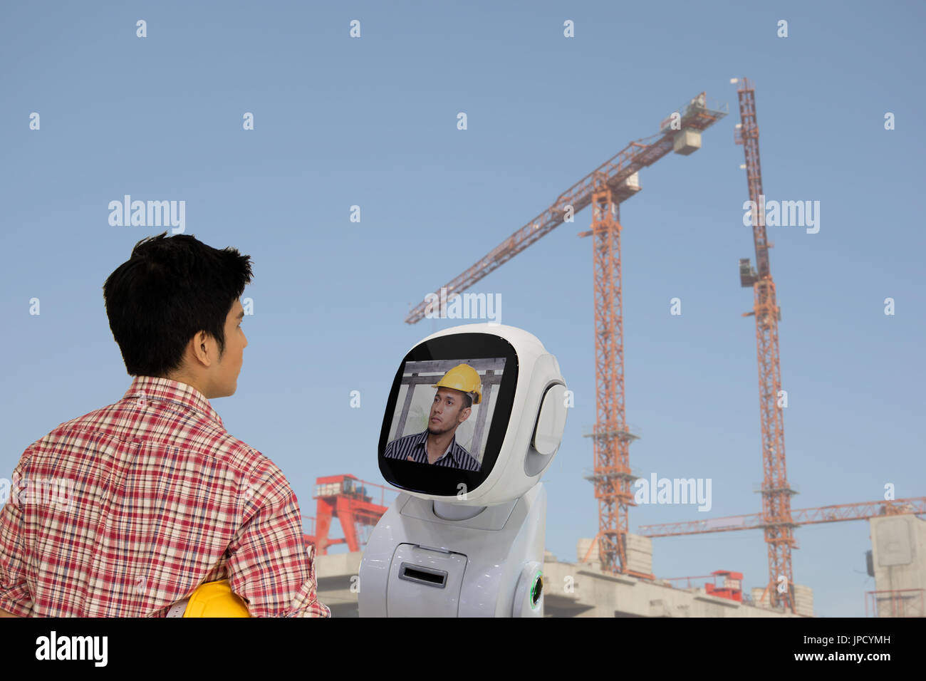 engineer use robot advisor technology to talk with boss or team mate for consult at construction site to improve a work ,a futuristic robot help a wor Stock Photo