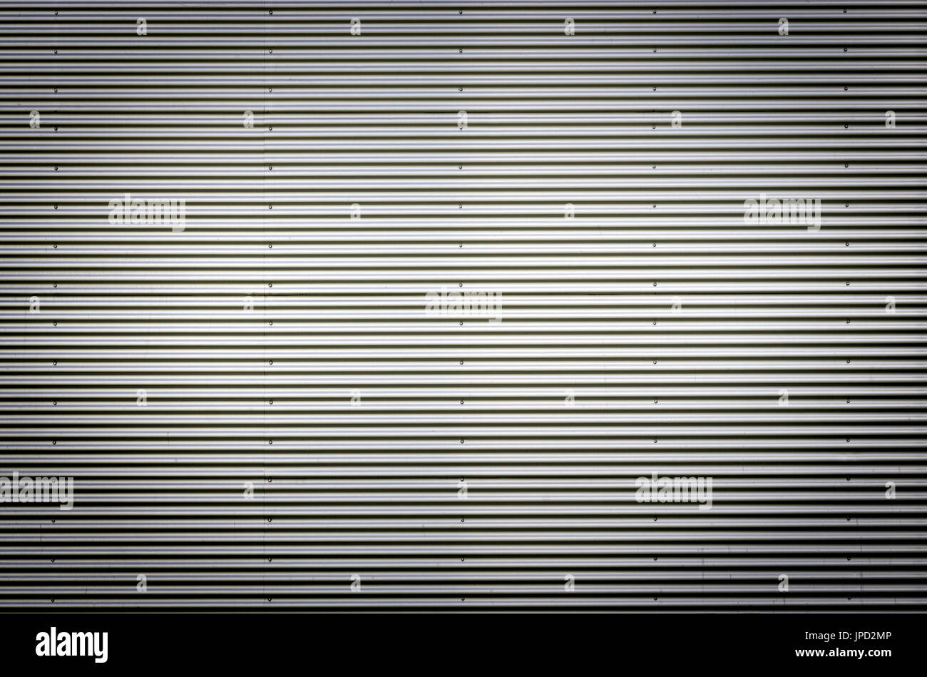 Corrugated metal sheet. Silver gray background pattern with nice vignetting. Stock Photo