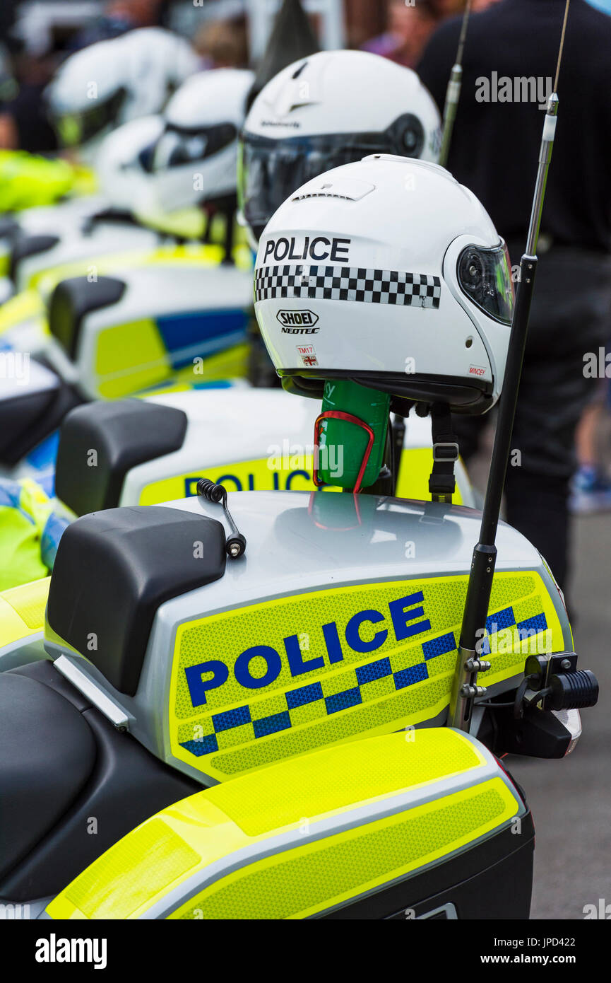 Сastle Douglas, Scotland, UK - September 4, 2016: A row of parked British police motorbikes with crash helmets sitting on the back of each bike. Stock Photo