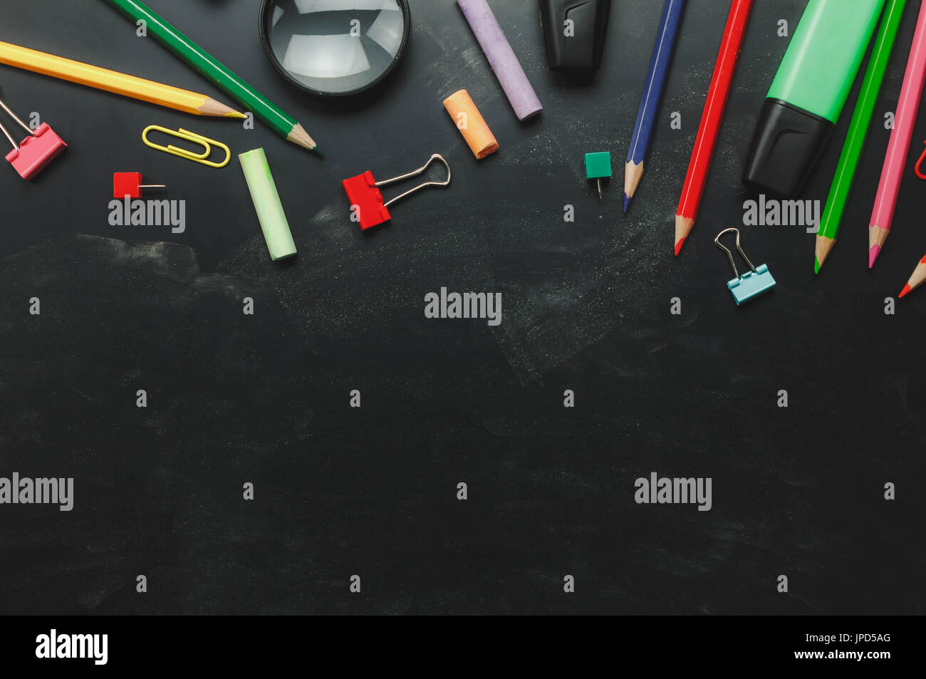 Top view accessories back to school or items desktop office desk background.Variety stationery on grunge blackboard with copy space for mock up and we Stock Photo