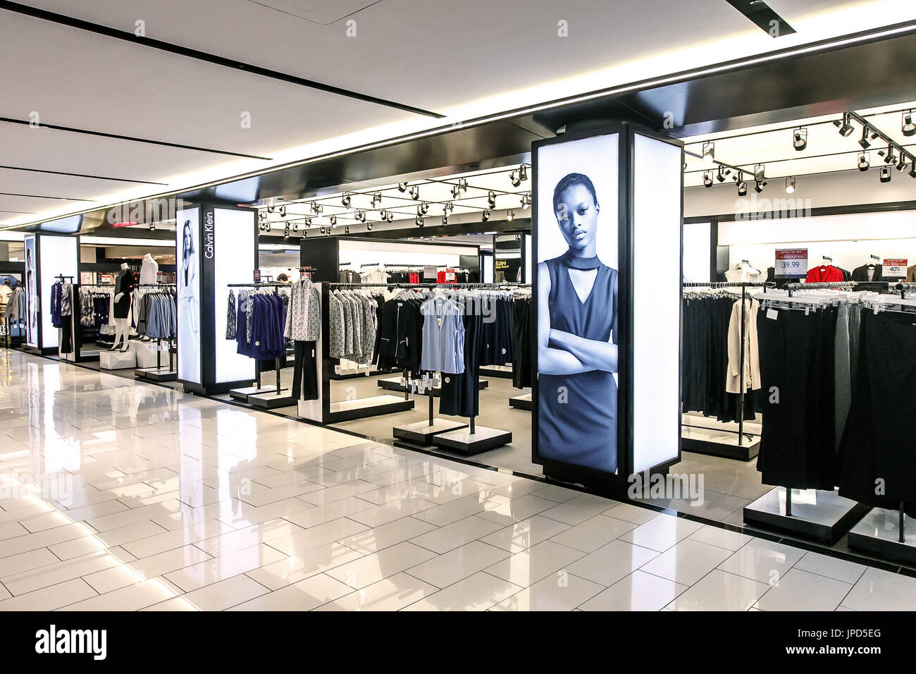 Various clothing items in the Calvin Klein section of Macy's are waiting to receive customers' attention. Stock Photo
