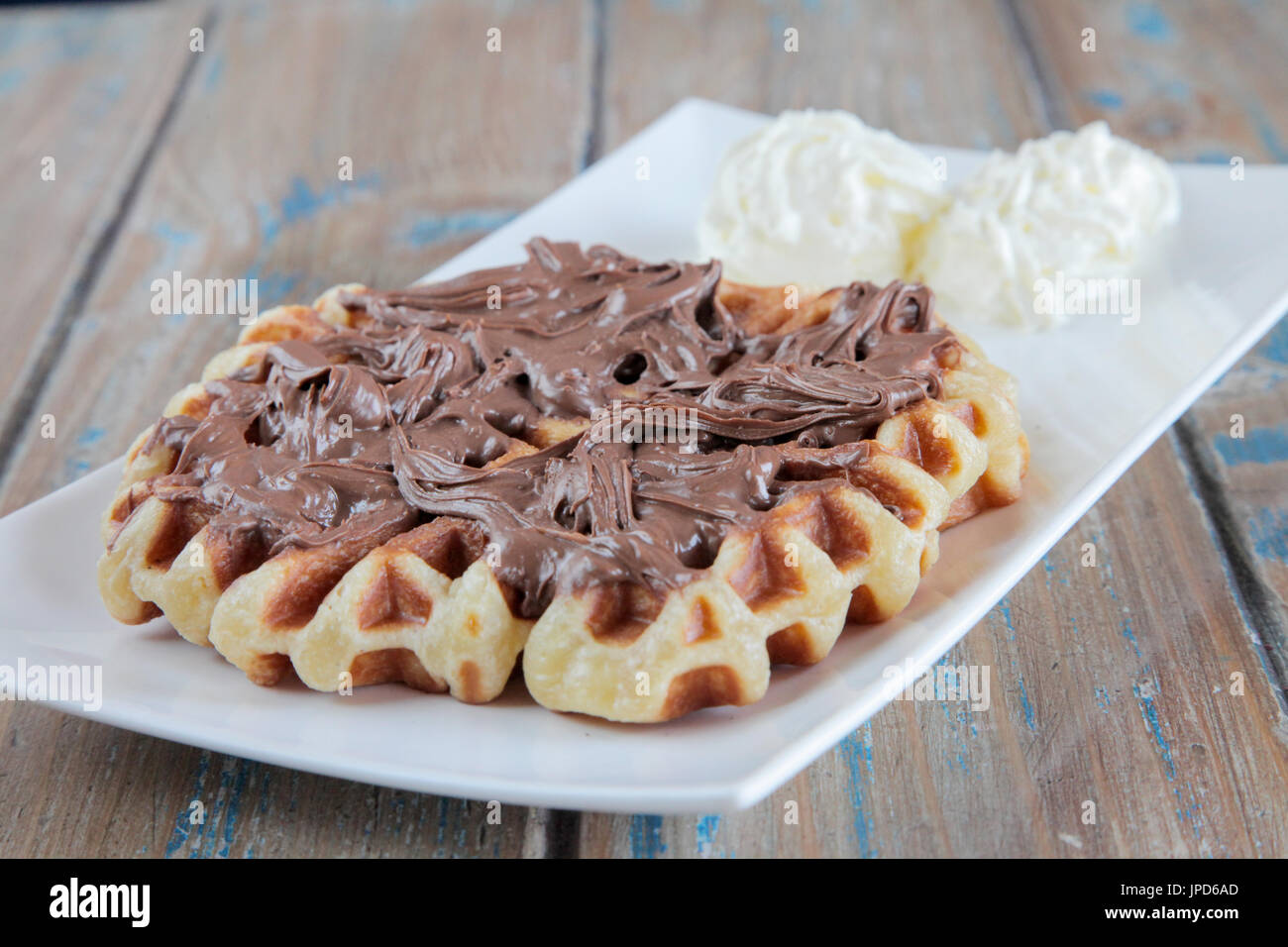 Nutella waffle with whipped cream Stock Photo - Alamy