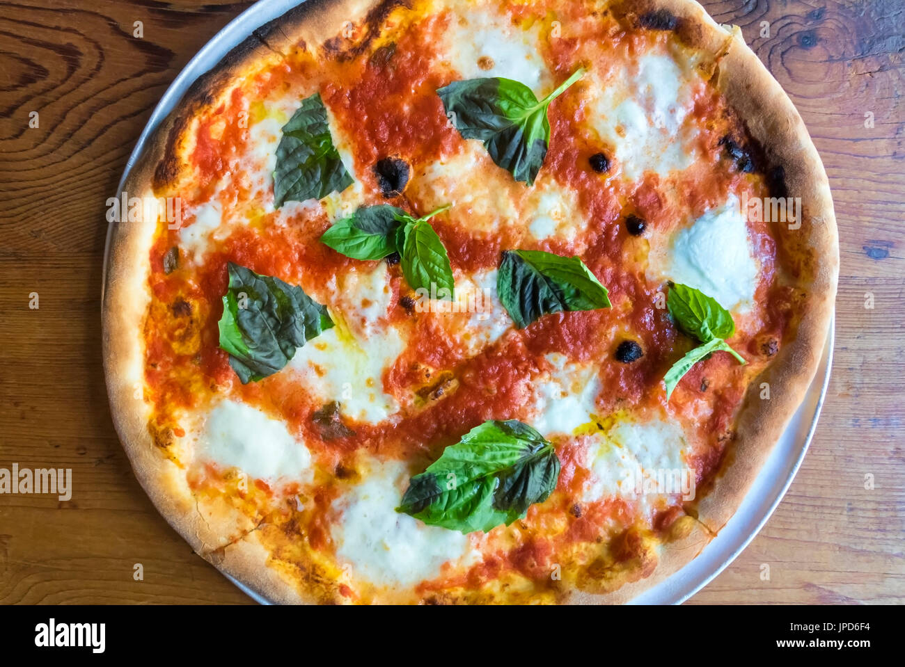 Pizza Margherita, a classic dish from Naples, Italy in the three colors of  the Italian flag: red, white, and green—tomato, cheese, and basil Stock  Photo - Alamy