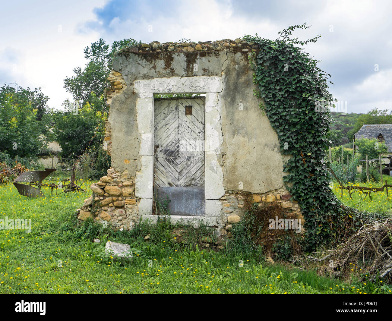 1736 doorway... only remains of house, Lacommande, France. Stock Photo