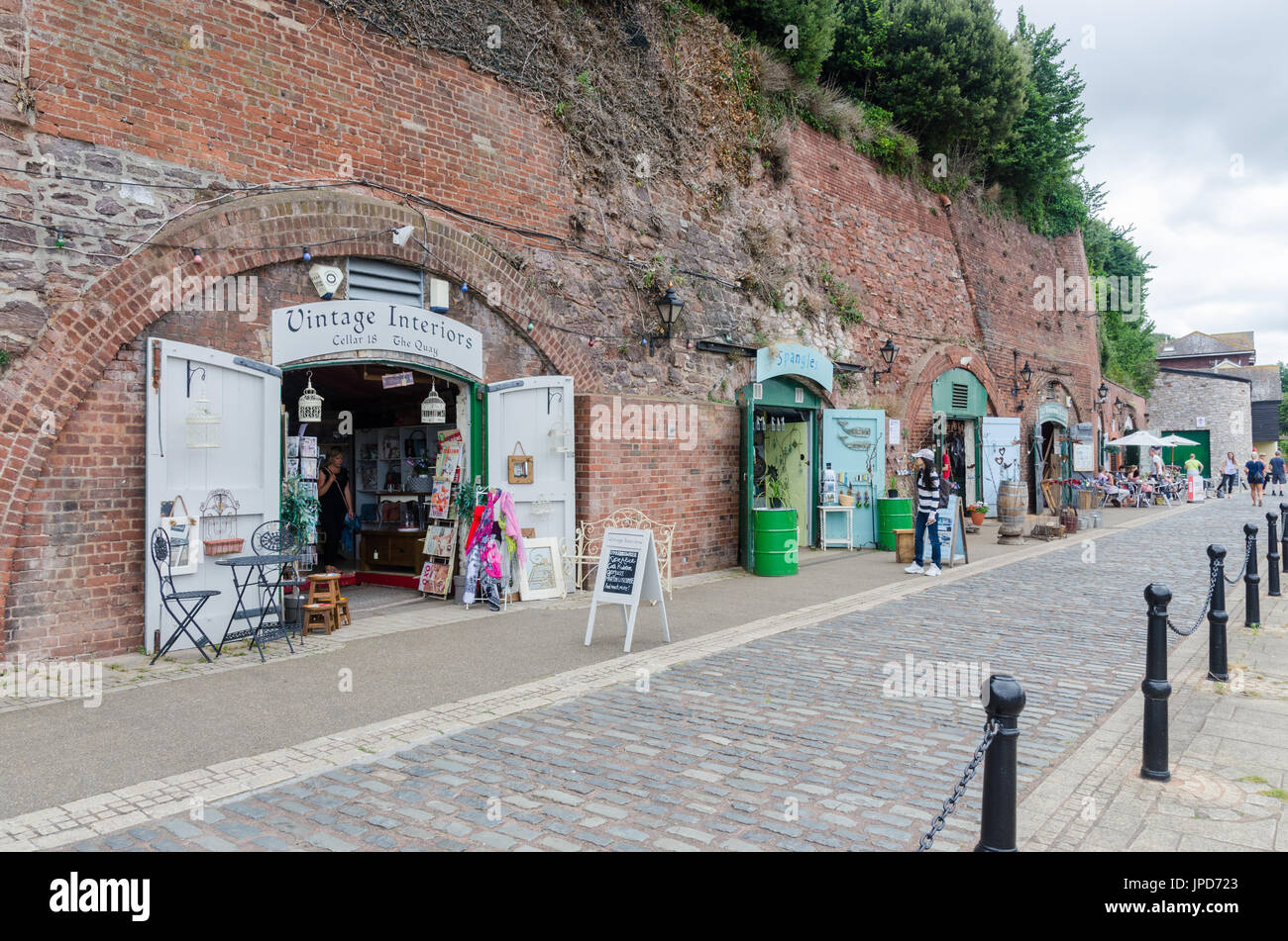 Shops and restaurants in the cellars on The Quay on the bank of the River Exe in Exeter, Devon Stock Photo