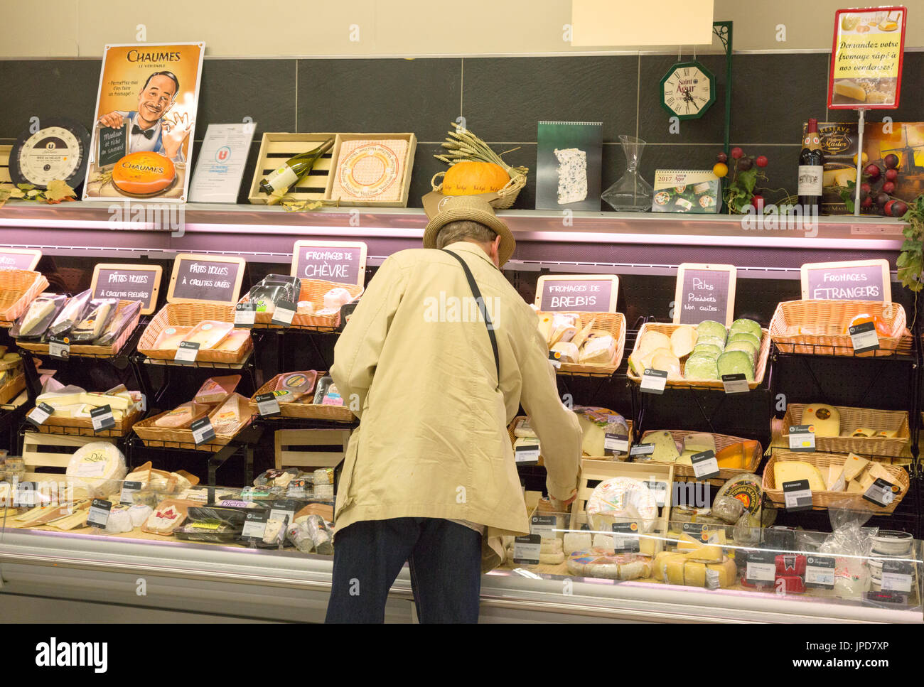 A man buying cheese at the cheese counter in a french  supermarket, Brittany, France Europe Stock Photo
