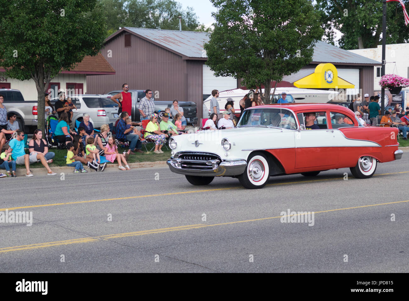 Restored 1955 Oldsmobile 88 participates in the 2017 annual Cruz-In parade for antique and vintage cars and trucks in Montague, Michigan. Stock Photo