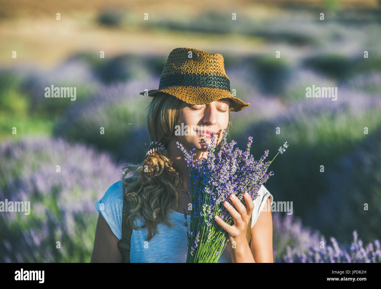 Young girl wearing straw hat with bouquet of lavender flowers Stock ...