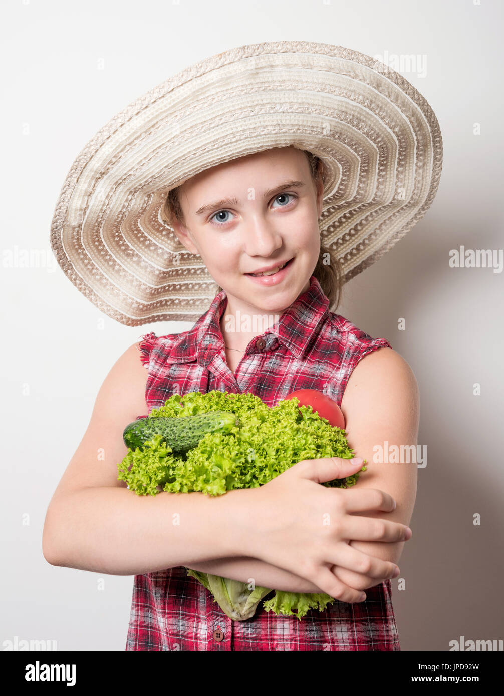 girl holding in the hands of tomato and cucumber Stock Photo - Alamy