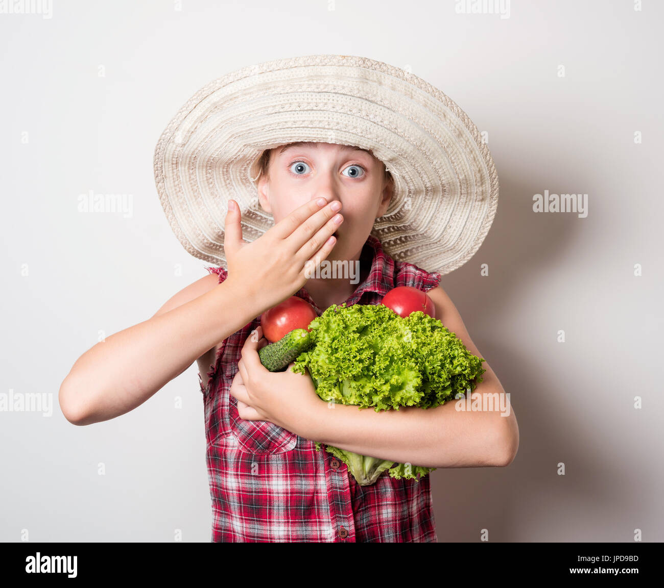 girl holding in the hands of tomato and cucumber Stock Photo - Alamy