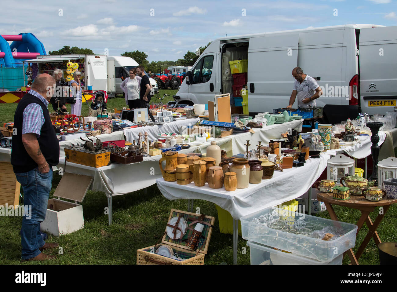 Man looking at items for sale at car boot sale at Ringmer steam and country show Stock Photo